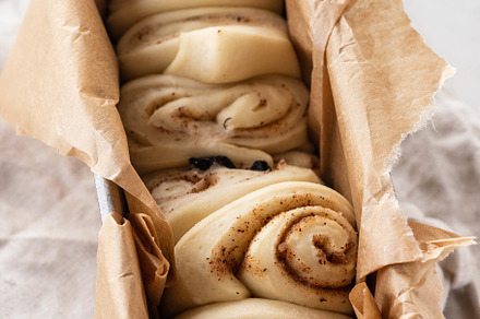 Raw cinnamon bread in a baking dish stock photo containing cinnamon and roll