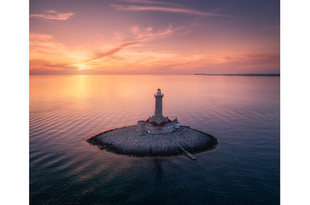 Lighthouse on smal island in the sea, an Architecture Photo by den-belitsky
