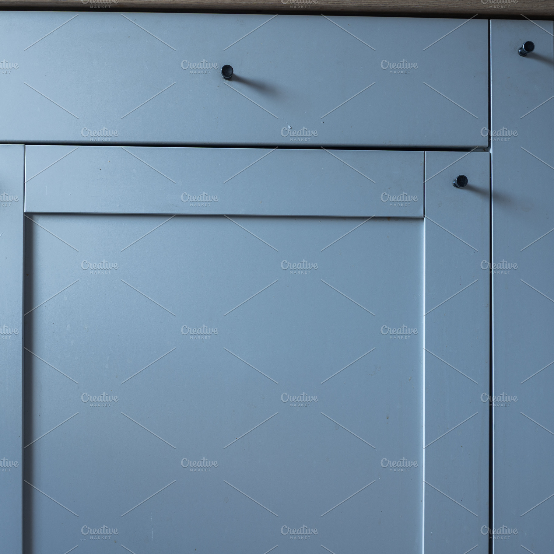 Minimalist kitchen cabinet door with a smooth blue surface and s, an Industrial Photo by MDBildes