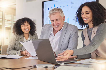 Happy, coaching and business people on laptop for creative, collaboration and project review in office. Corporate, women and mentor with report for review, planning or teamwork idea for proposal, a Photo by Peopleimages.com