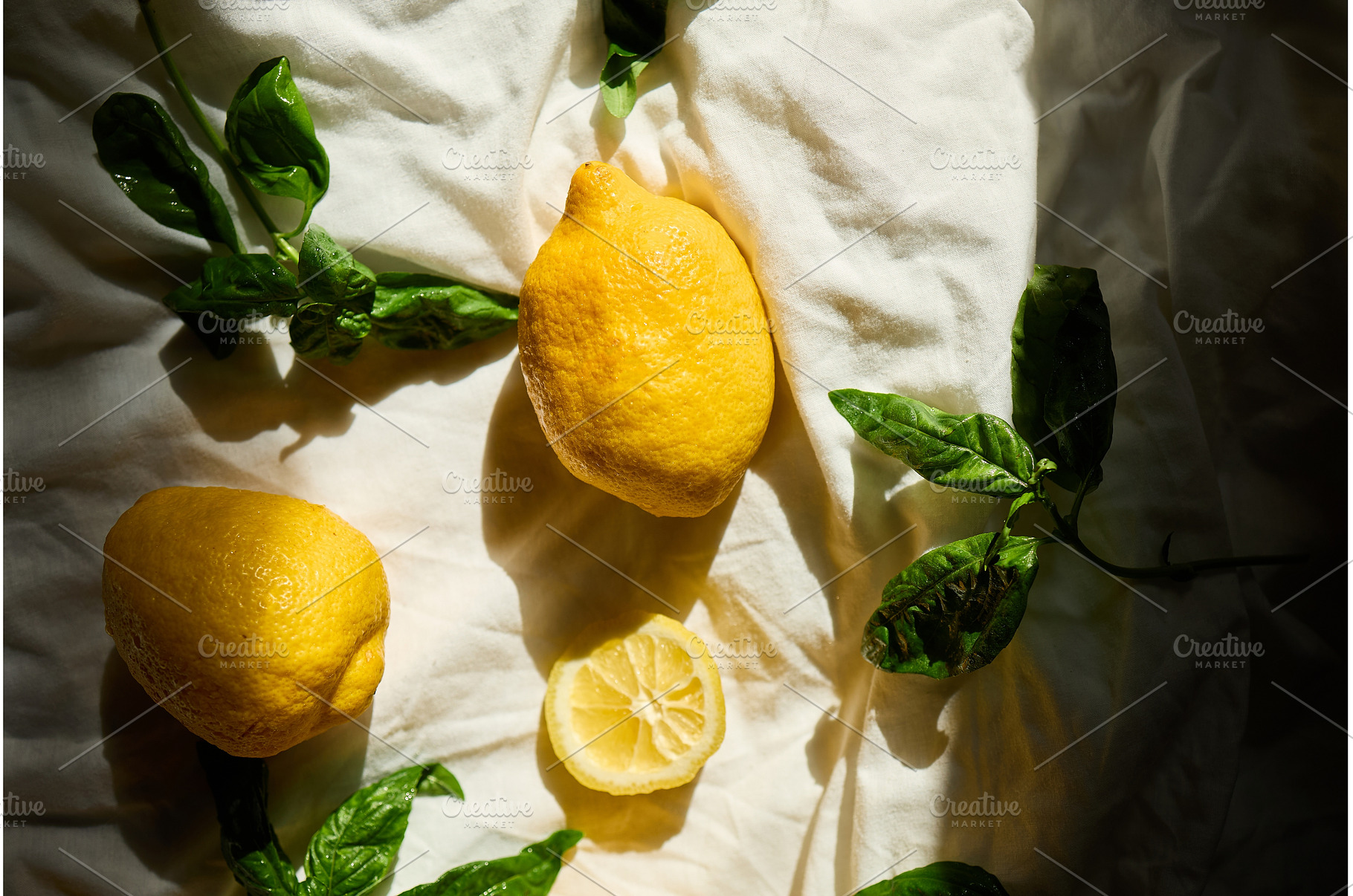 Bright yellow lemons and fresh basil, a Food & Drink Photo by IlliaBondarPhotography