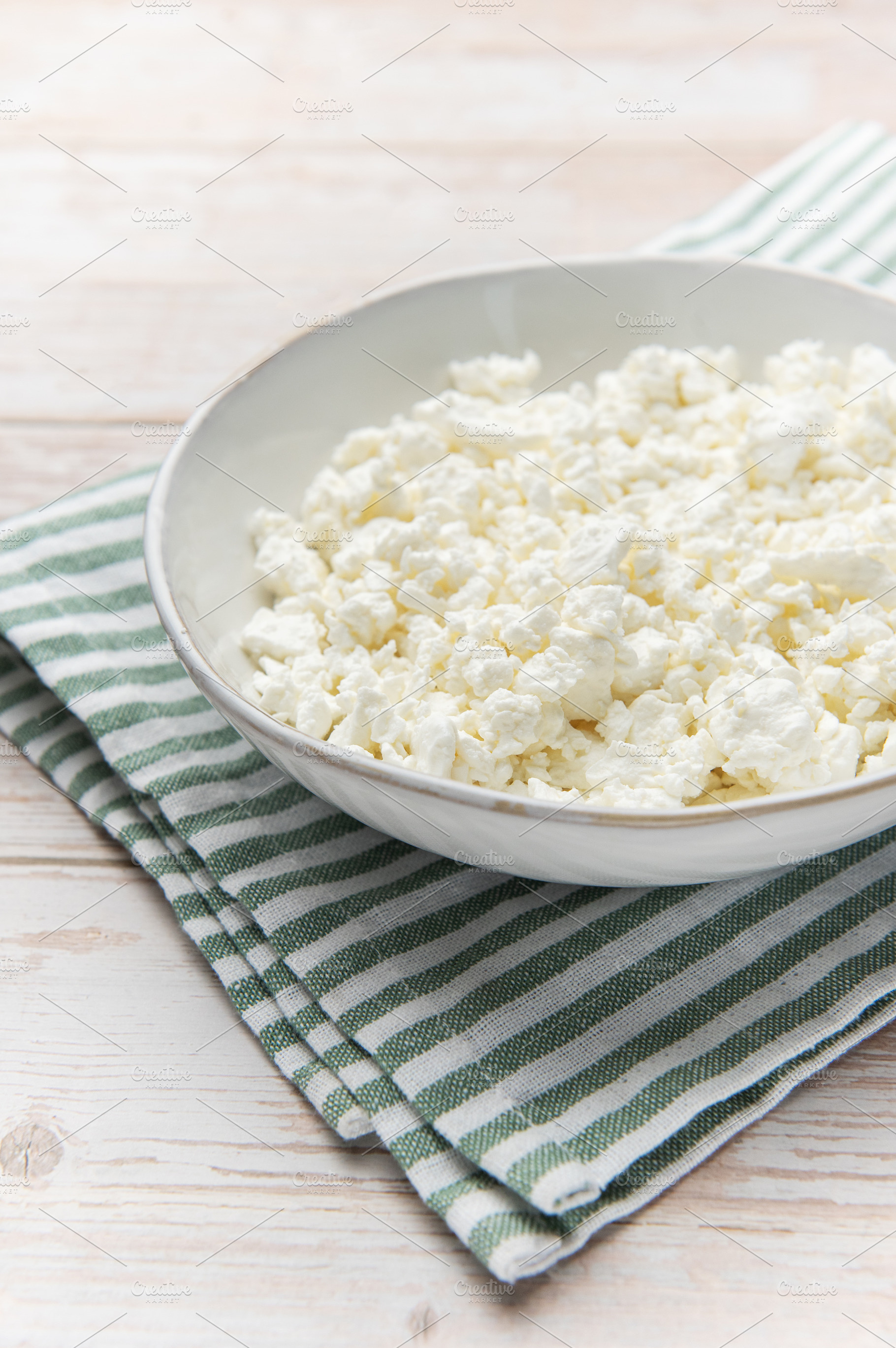 Cottage cheese in bowl with striped napkin, a Food & Drink Photo by Olena Rudo