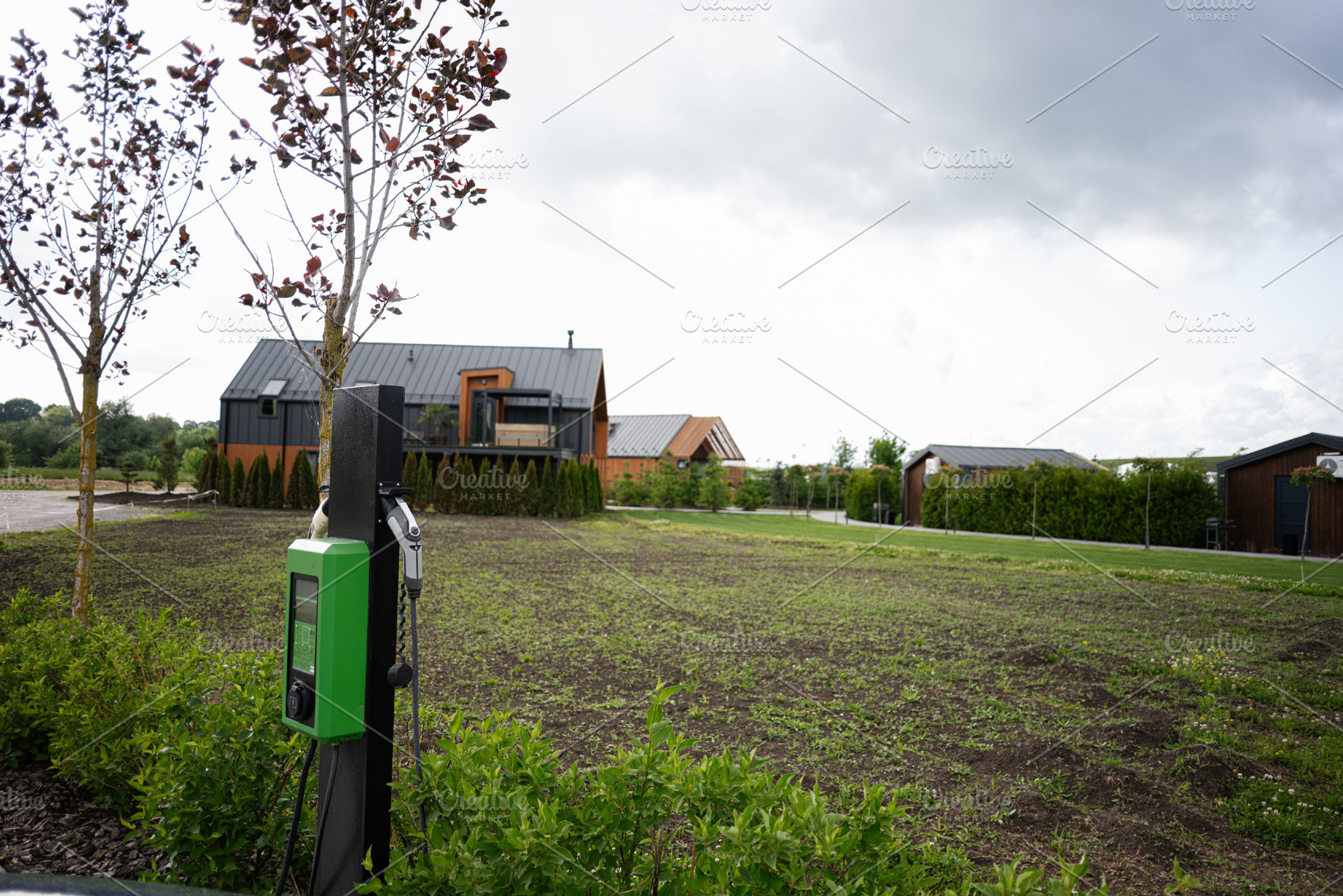 Electric vehicle charging at a rural home with modern design architecture, a Photo by AS photostudio