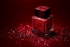 Red glitter cosmetic bottle shimmering on a crimson background,, a Photo by Studio ANNA