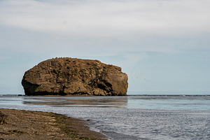 Towering rocky island rising above, a Nature Photo by Elena Vagengeim