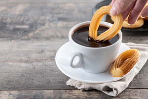 Eating traditional Spanish churros with hot chocolate, a Food & Drink Photo by etorres69