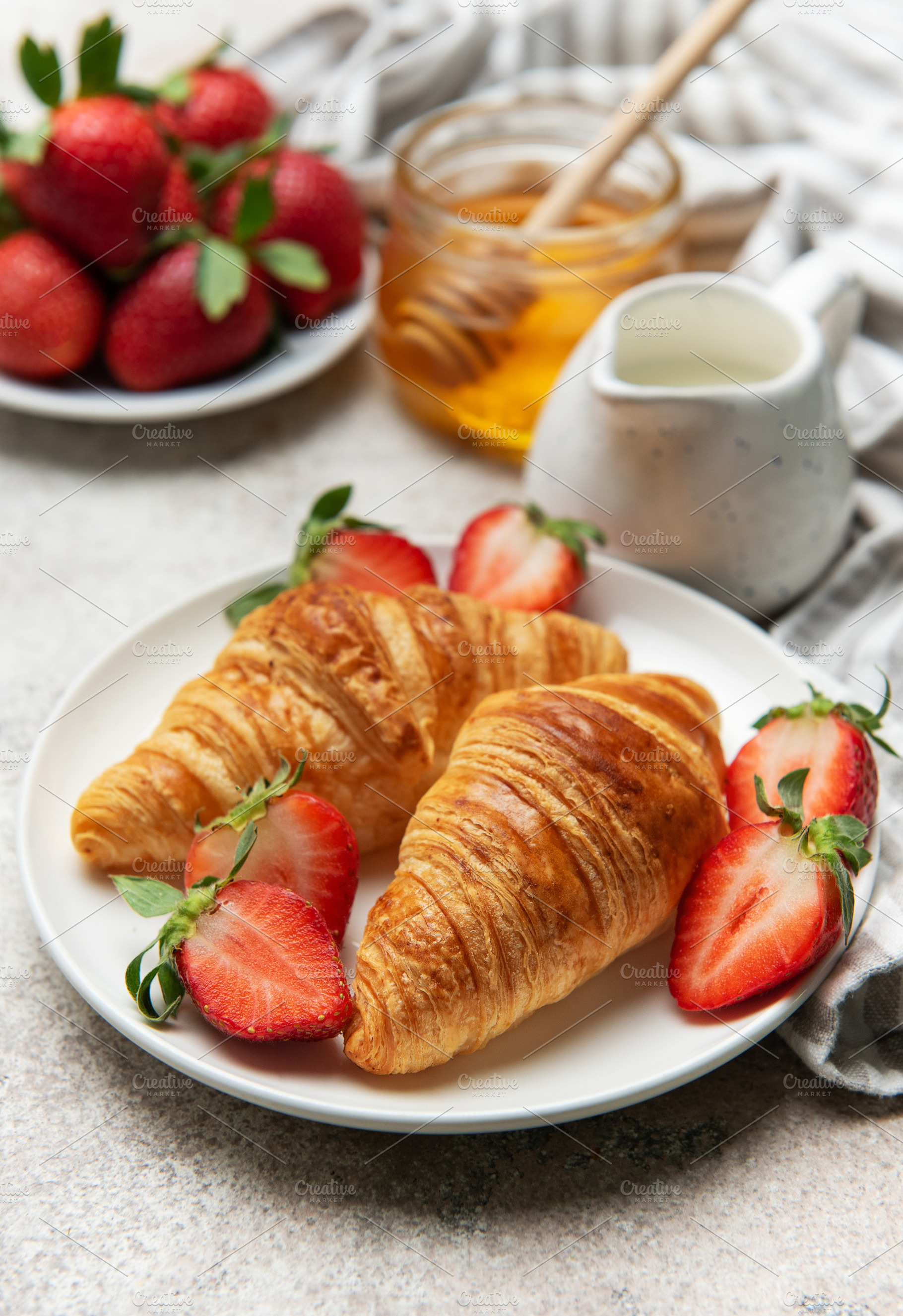 Delicious french croissants with fresh strawberries and honey fo, a Food & Drink Photo by Olena Rudo