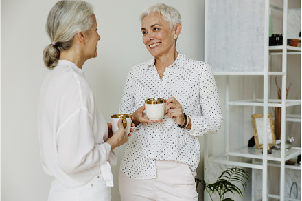 Two smiling middle aged female