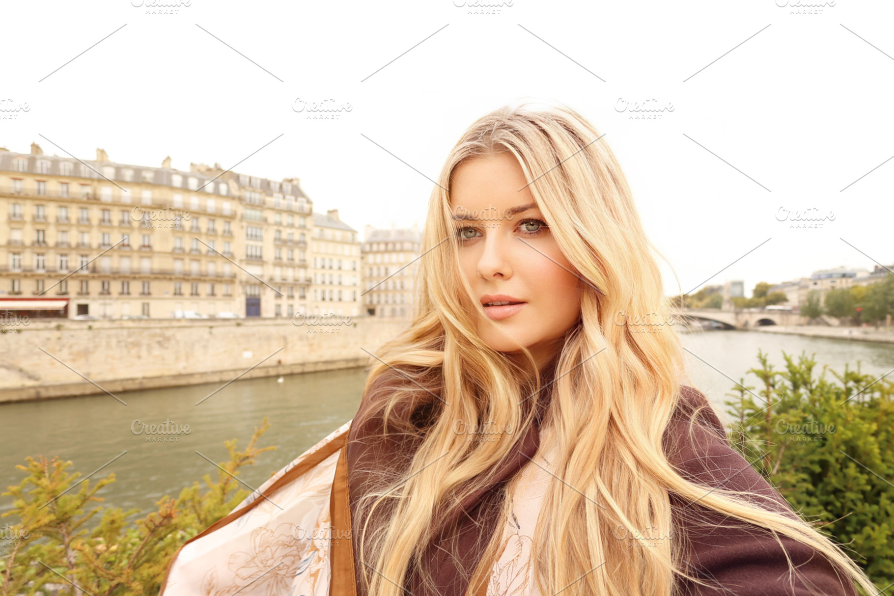Young blonde woman posing outdoors, overlooking the Seine River, a Person Photo by Studio ANNA
