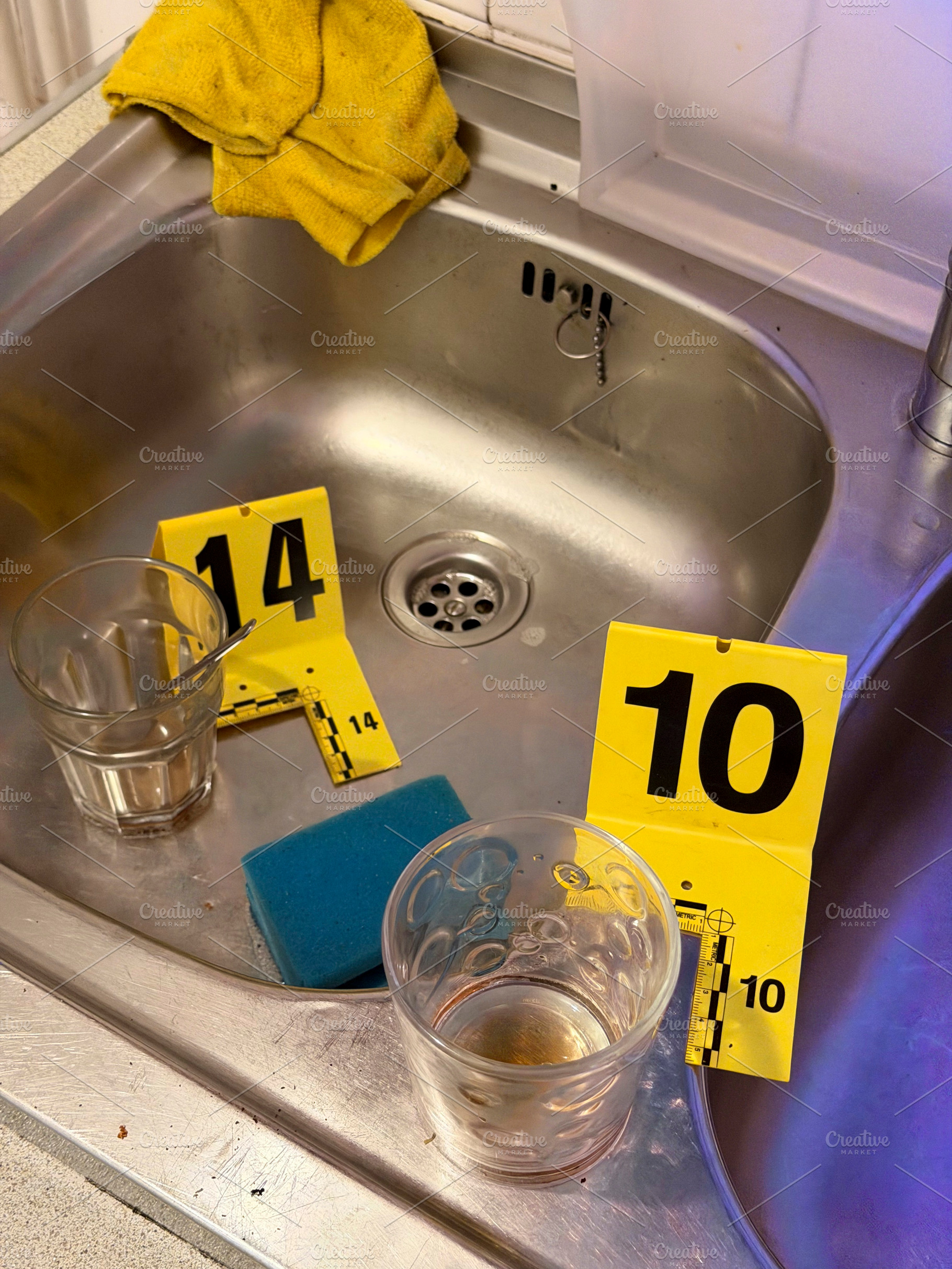 Criminal investigation marking evidence in kitchen sink, an Industrial Photo by karrastock