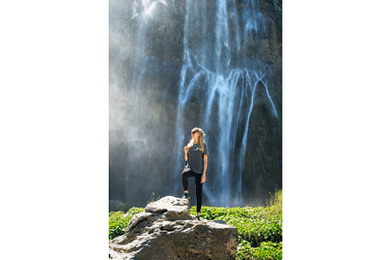 Young woman standing on a rock near, a Person Photo by den-belitsky