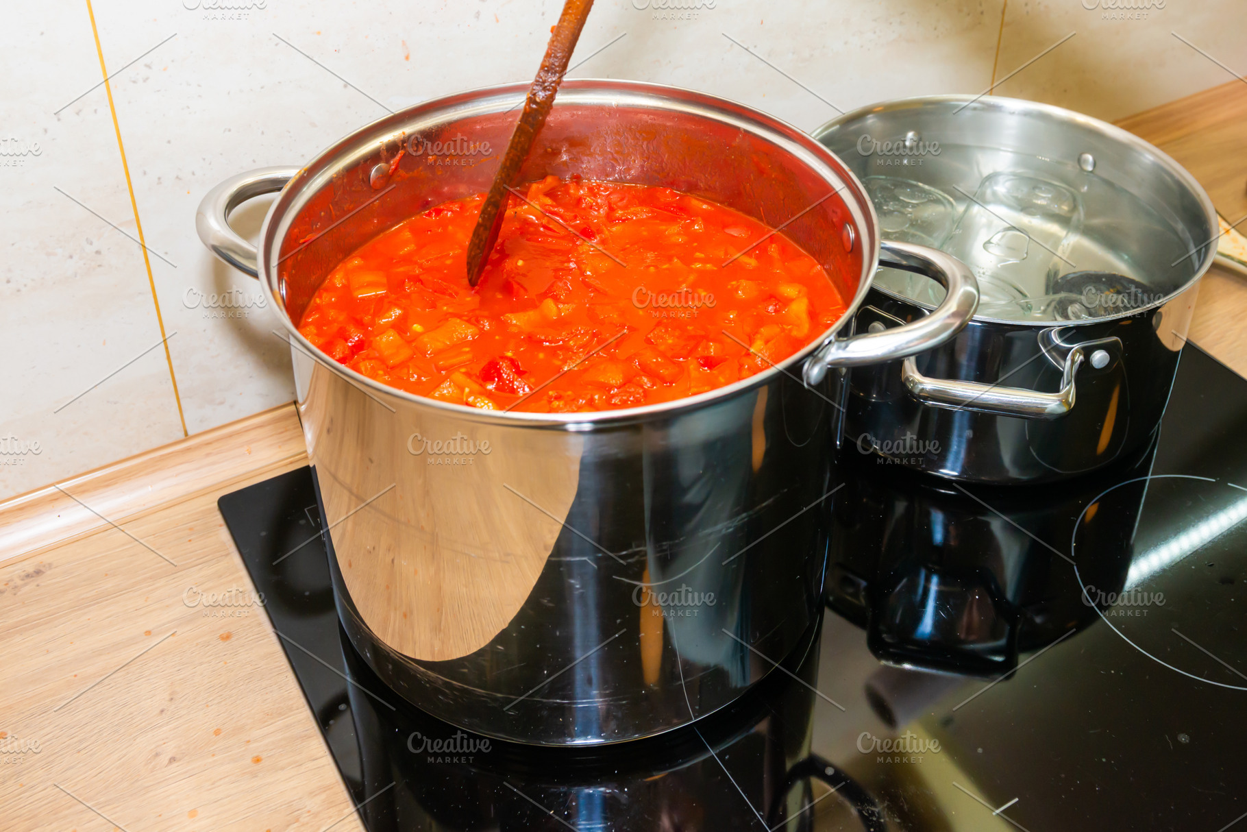 Cooking tomato sauce in big cooking pot, a Food & Drink Photo by Vapi