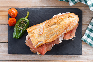 Spanish serrano ham sandwich on wooden table. Spanish bocadillo de jamon serran, a Food & Drink Photo by etorres69