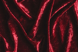 Red crushed velvet fabric creating an opulent background with its soft, rich te, a Photo by Studio ANNA