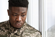 Unhappy military black man standing next to window, a Photo by Prostock-Studio (Thumbnail 7 of 7)