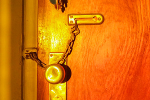 Warm toned door handle casting shadow, an Architecture Photo by DanFLCreativo