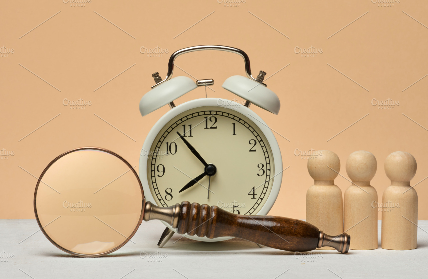 White vintage alarm clock, magnifying glass and three wooden hum, a Business Photo by ndanko