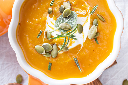 Pumpkin soup in a bowl containing pumpkin, soup, and rosemary, a Food & Drink Photo by farwasser