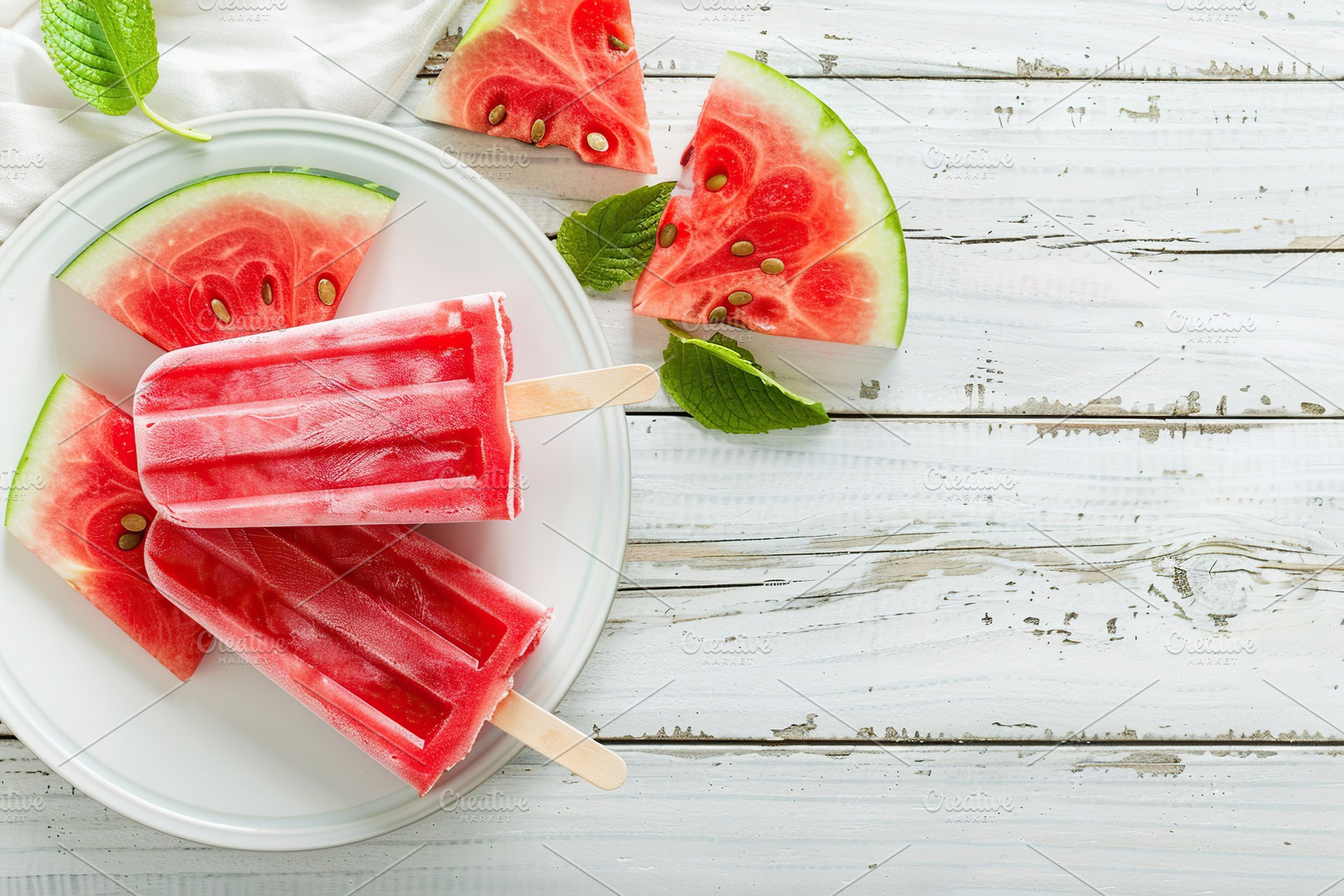 Ice cream popsicles with watermelon in plate on wooden background, a Food & Drink Photo by AlyaAnd
