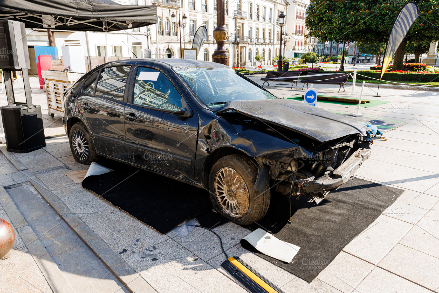 Damaged Black Car on Display in a City Square, Lugo, Spain, a Transportation Photo by Bepslabor