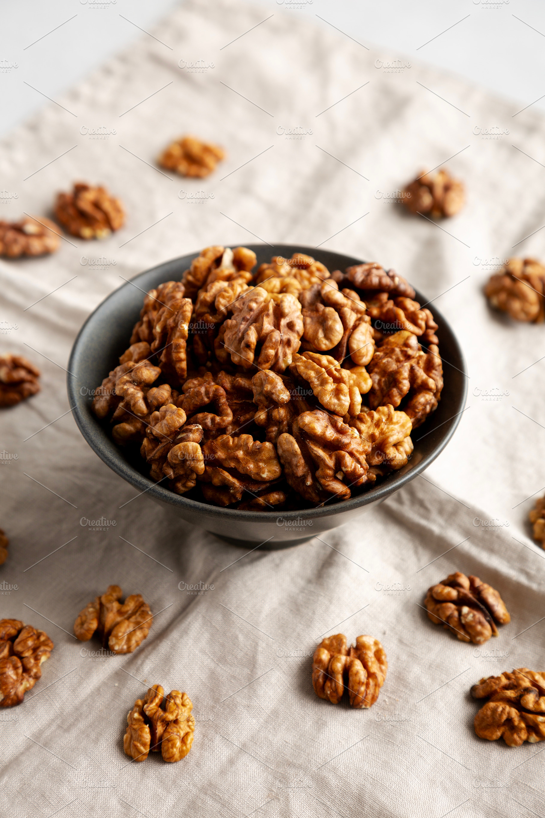 Raw Walnut Halfs in a Bowl, side view., a Food & Drink Photo by LiudmylaChuhunova