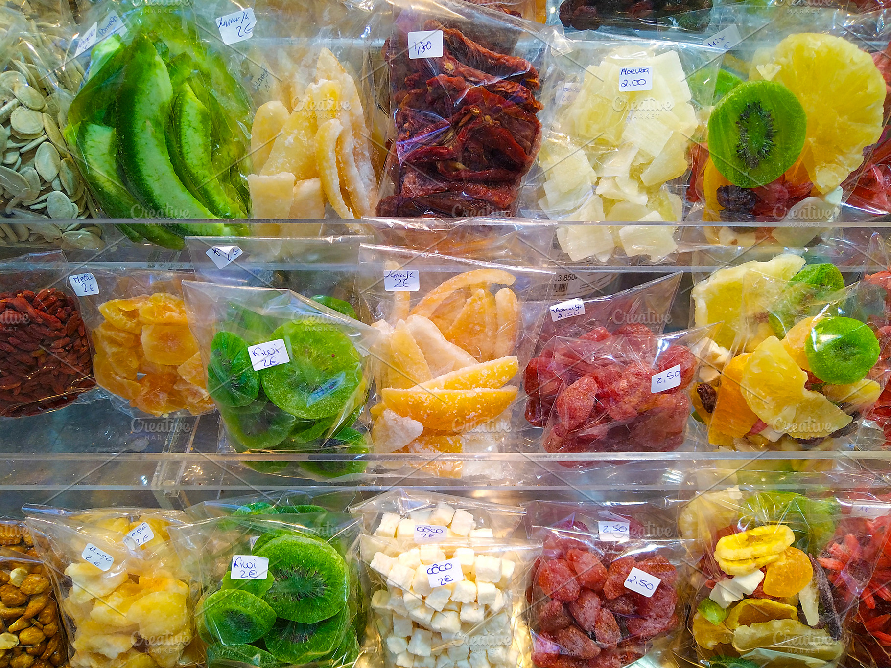 Colorful dried fruits at market stall, a Food & Drink Photo by DanFLCreativo