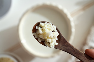 Kefir grains on a wooden spoon, top view