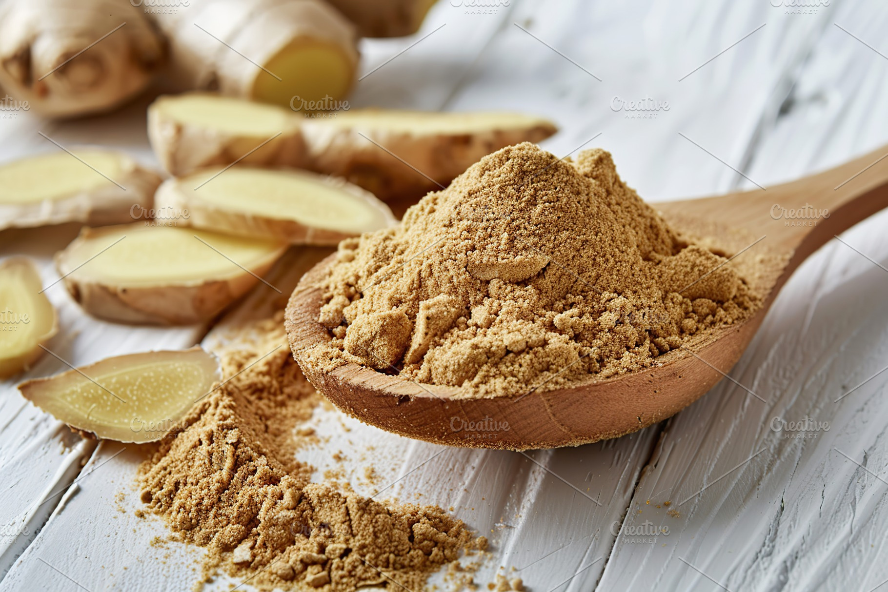 Ground dry ginger in wooden spoon on white wooden background, a Food & Drink Photo by AlyaAnd