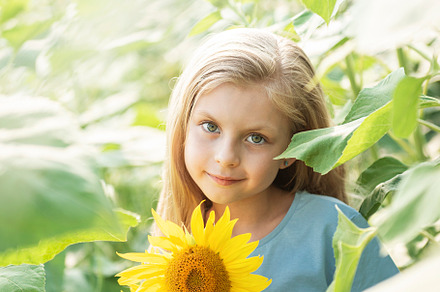 Beautiful little girl in sunflowers, a Person Photo by Olena Rudo