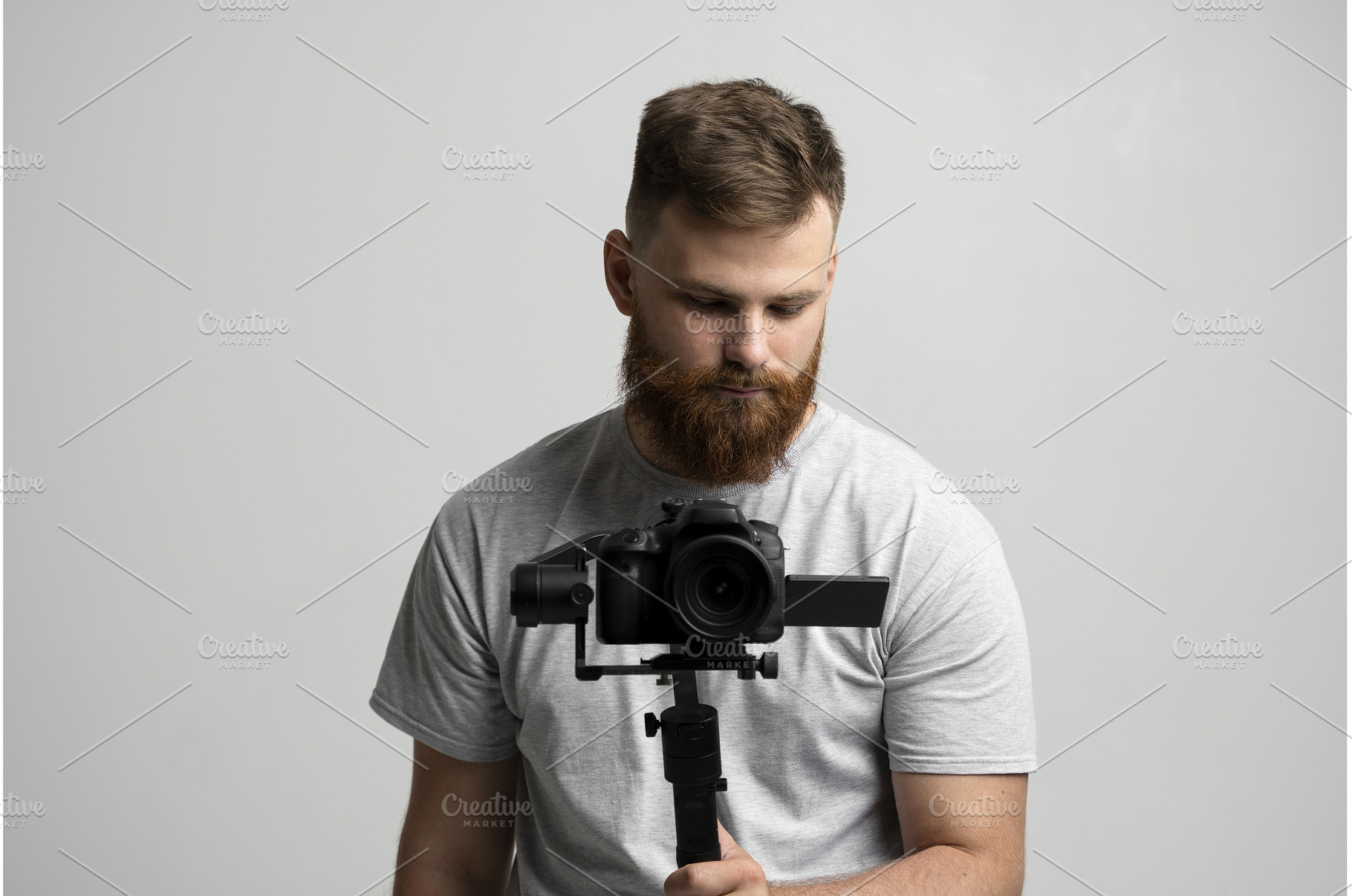 Bearded man holding professional, a Person Photo by volodymyrshtun13795