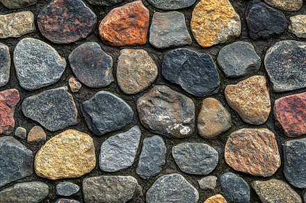 Textured stone wall featuring various shapes and colors of stones, including gr, a Texture Graphic by Textures & Backgrounds