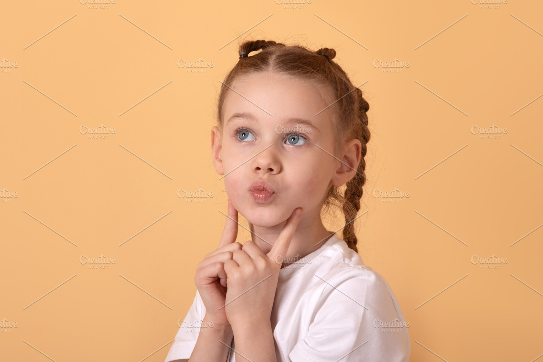 Portrait of a young girl with braided hair in a white shirt, pos, a Person Photo by Ales Munt