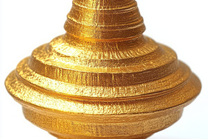 A shiny gold spinning top with a sleek, intricate design, set against a clean w, a Background Photo by ImageMir