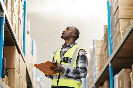 Young logistic supervisor checking package details in a warehouse, a Person Photo by Jacob Lund