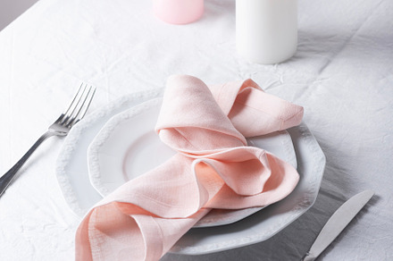 Pink linen napkins on the white table