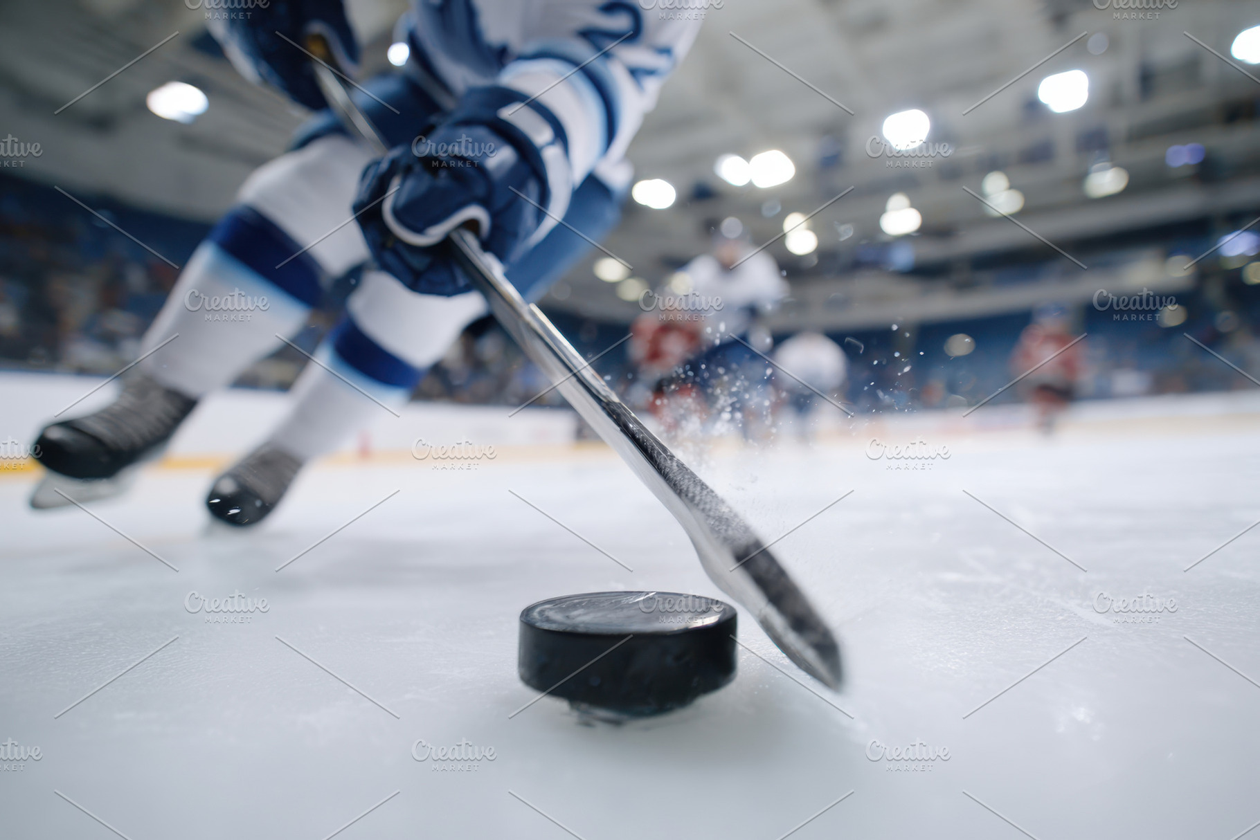 Dynamic hockey player in action on ice, a Sports & Recreation Photo by AlyaAnd