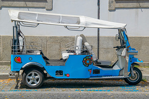 Electric vehicle parked at street, a Transportation Photo by DanFLCreativo