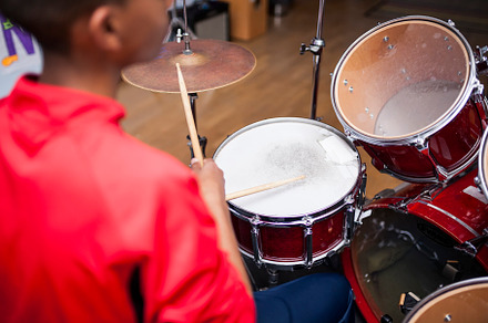 Drum class in a music school containing fun, kid, and boy