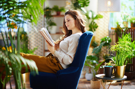 relaxed trendy woman with long wavy hair at home in sunny day, a Person Photo by Alliance Images