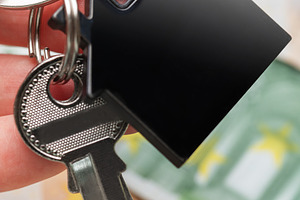 Hand holding house keys over euro currency, a Business Photo by Olena Rudo