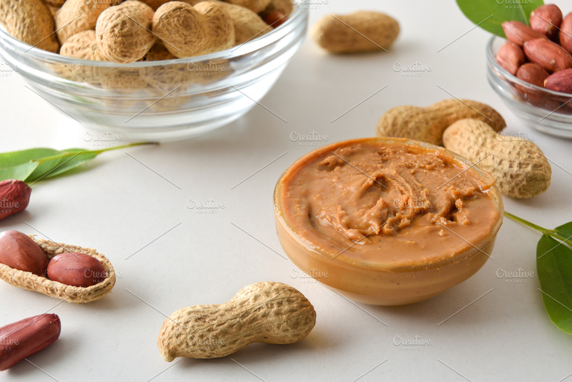 Bowl full of peanut butter on white table with fruits, a Food & Drink Photo by Davizro's Market