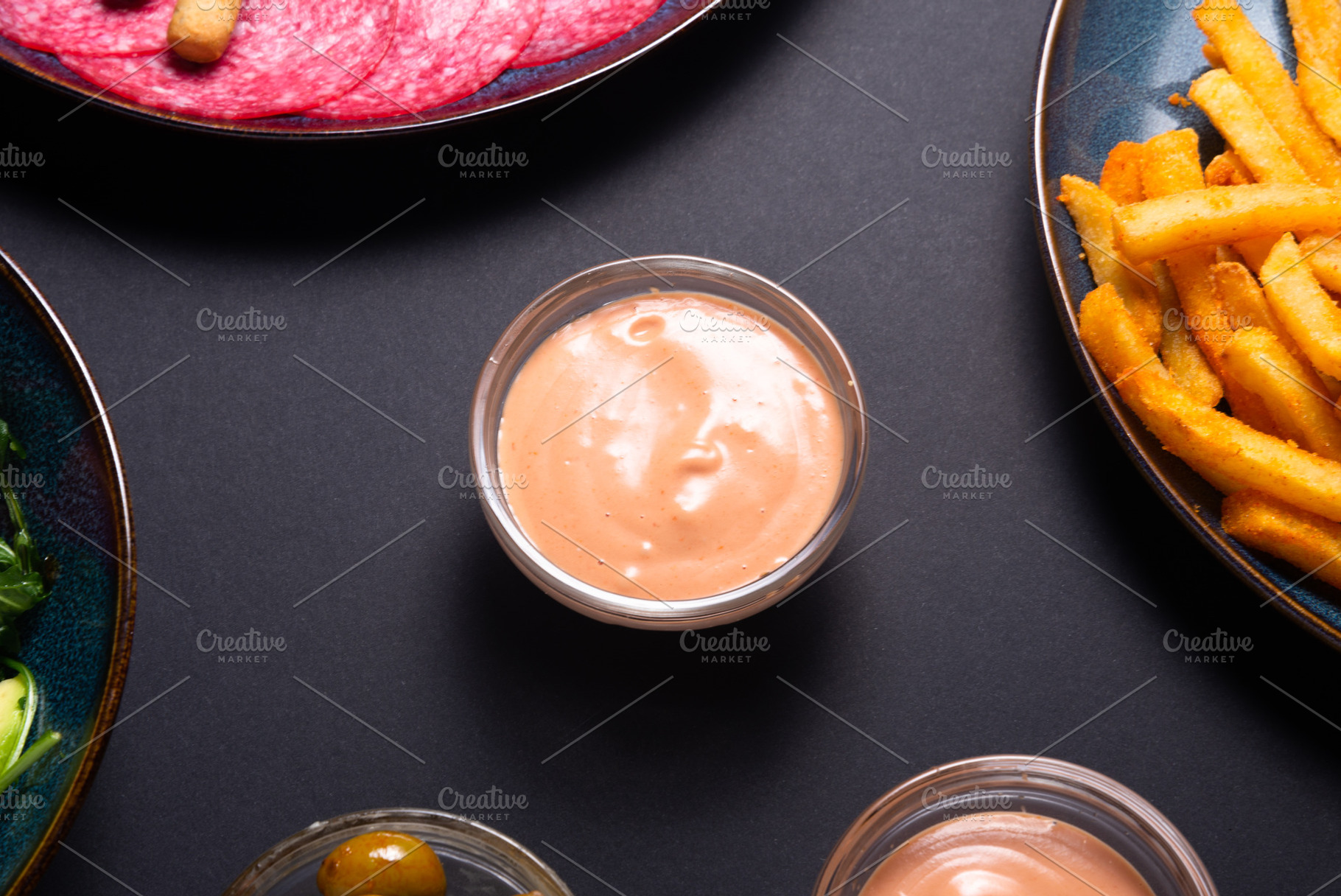 Creamy garlic sauce in a small glass bowl on a dark background., a Food & Drink Photo by MDBildes