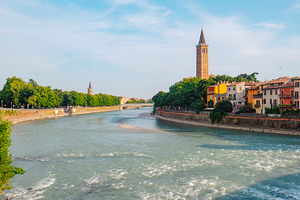 a wide view of the Adige River in Verona, Italy, a Photo by Nito