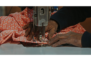 Indian tailor working with red, a Beauty & Fashion Photo by Our Amazing World