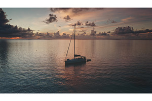 Sailboat floating on calm ocean at, a Nature Photo by Goinyk