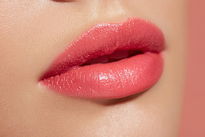 Woman's glossy pink lips close up showcasing beauty, cosmetic ap, a Photo by Studio ANNA