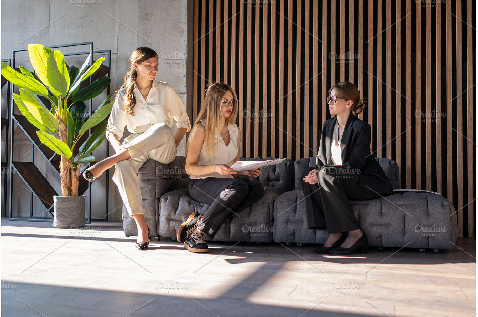Three businesswomen are sitting on a, a Person Photo by undrey