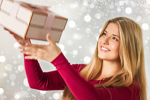 Happy young woman catching a holiday gift box, smiling, celebrat, a Person Photo by Studio ANNA