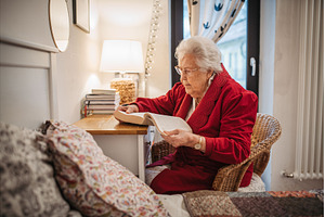 Senior woman relaxing and reading, a Sports & Recreation Photo by HalfPoint