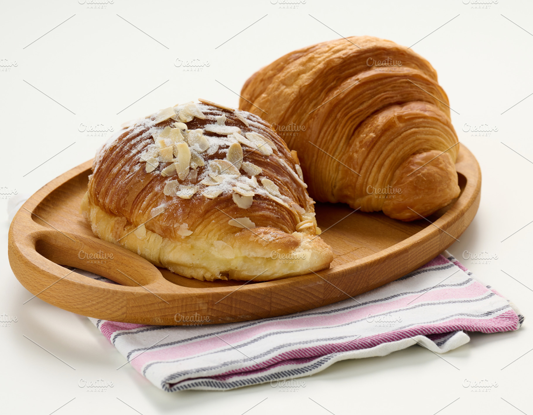 Baked crisp croissant on wooden board, white table. Breakfast, a Food & Drink Photo by ndanko